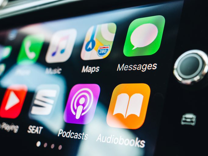 Woman pressing button on the Apple CarPlay Apple CarPlay installation Sacramento